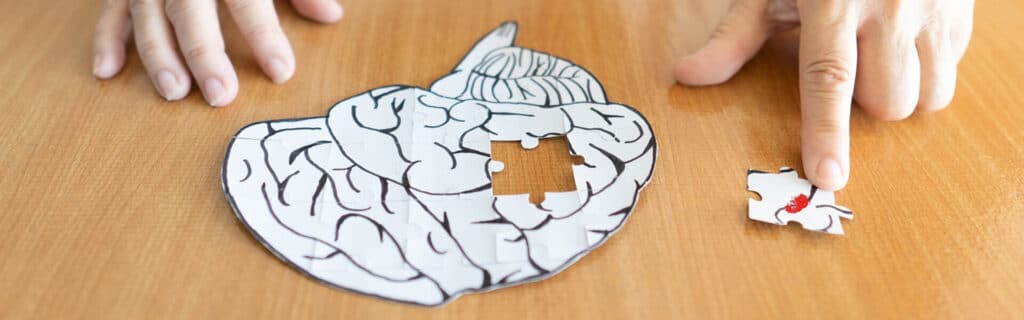 Stroke symbolically represented through paper jigsaw of the brain with a piece removed