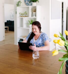 Client holding ipad during telehealth consultation